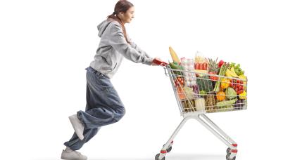 teenager with full shopping cart running