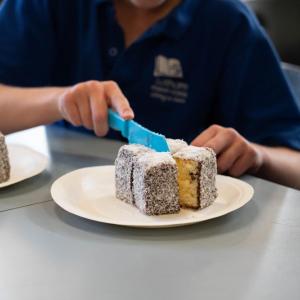 Students cut lamingtons
