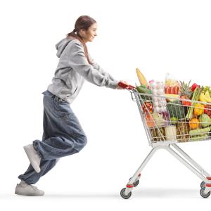 teenager with full shopping cart running