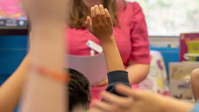 Students with their hands raised