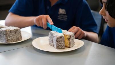 Students cut lamingtons
