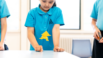 Students jump an origami frog