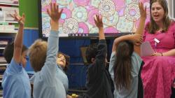 Students with their hands raised