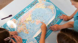 Students look at world map