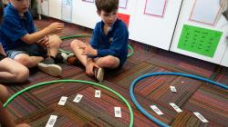 Students sort number cards into hoops