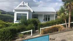 A house on Baldwin street with a triangle labelled 'rise' and 'run' superimposed over the street in front of it. 